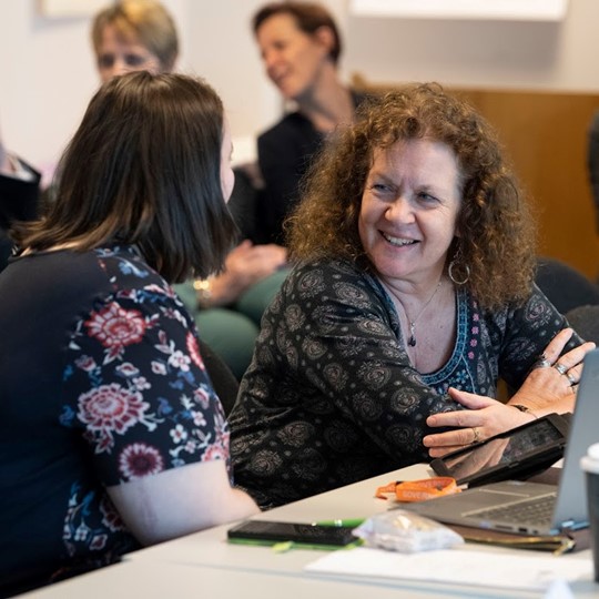 Group Of Teachers In A Meeting With A Laptop
