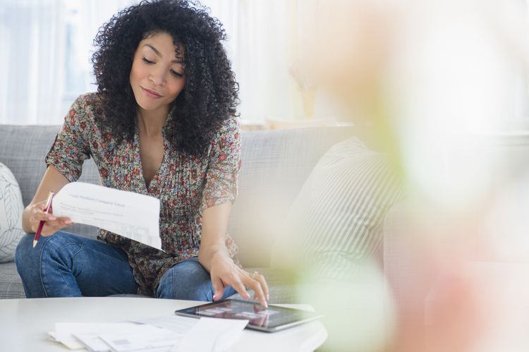 A woman looks down at her computer.